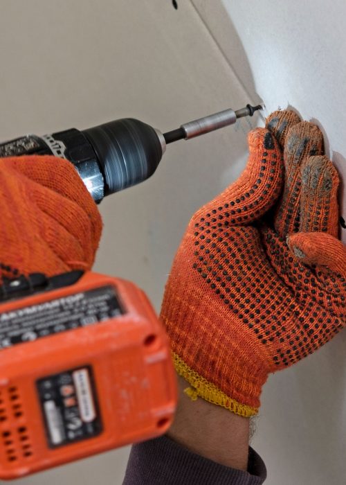 Fastening drywall process in close-up